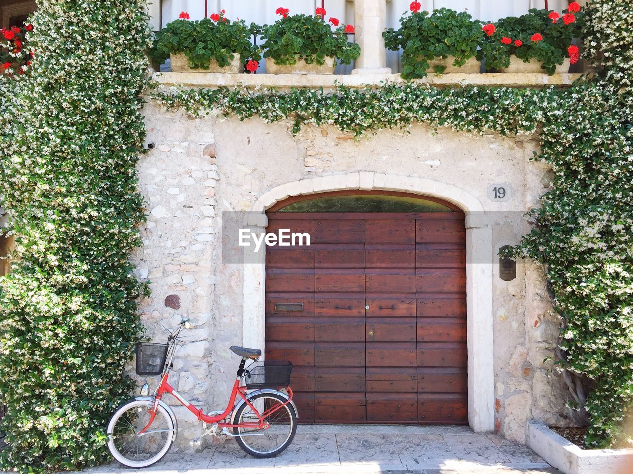 BICYCLE PARKED AGAINST BUILDING