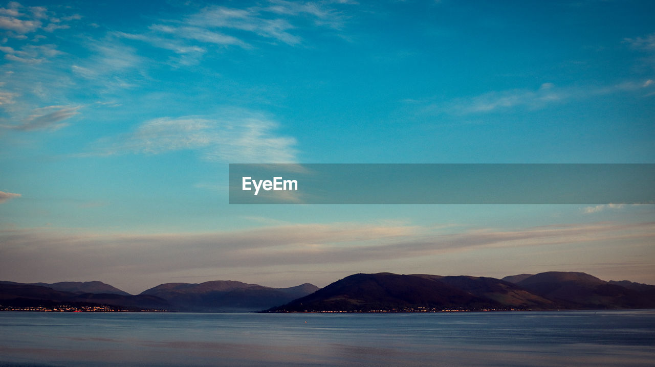 sky, horizon, mountain, dawn, water, scenics - nature, cloud, sea, beauty in nature, reflection, sunrise, nature, ocean, morning, environment, tranquility, landscape, tranquil scene, land, no people, mountain range, travel destinations, coast, travel, sunlight, outdoors, body of water, blue, beach, shore, idyllic, bay, dramatic sky