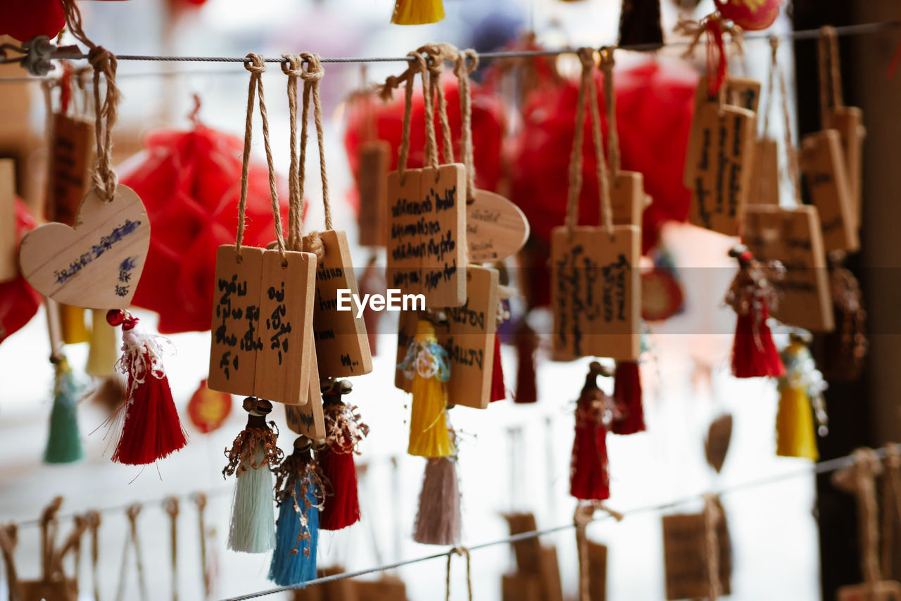 CLOSE-UP OF LANTERNS HANGING ON TEMPLE