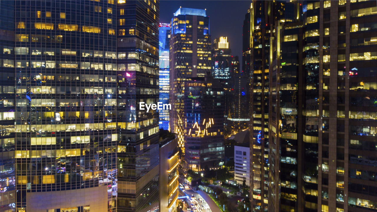 Illuminated modern buildings in city at night