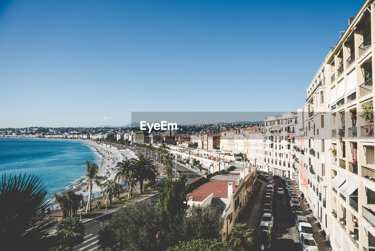Panoramic view of buildings and sea against clear blue sky