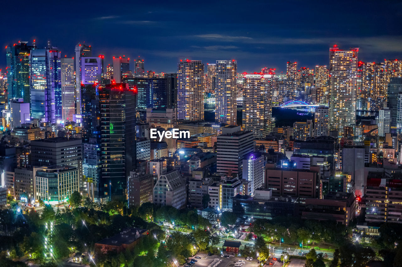 ILLUMINATED CITY BUILDINGS AT NIGHT