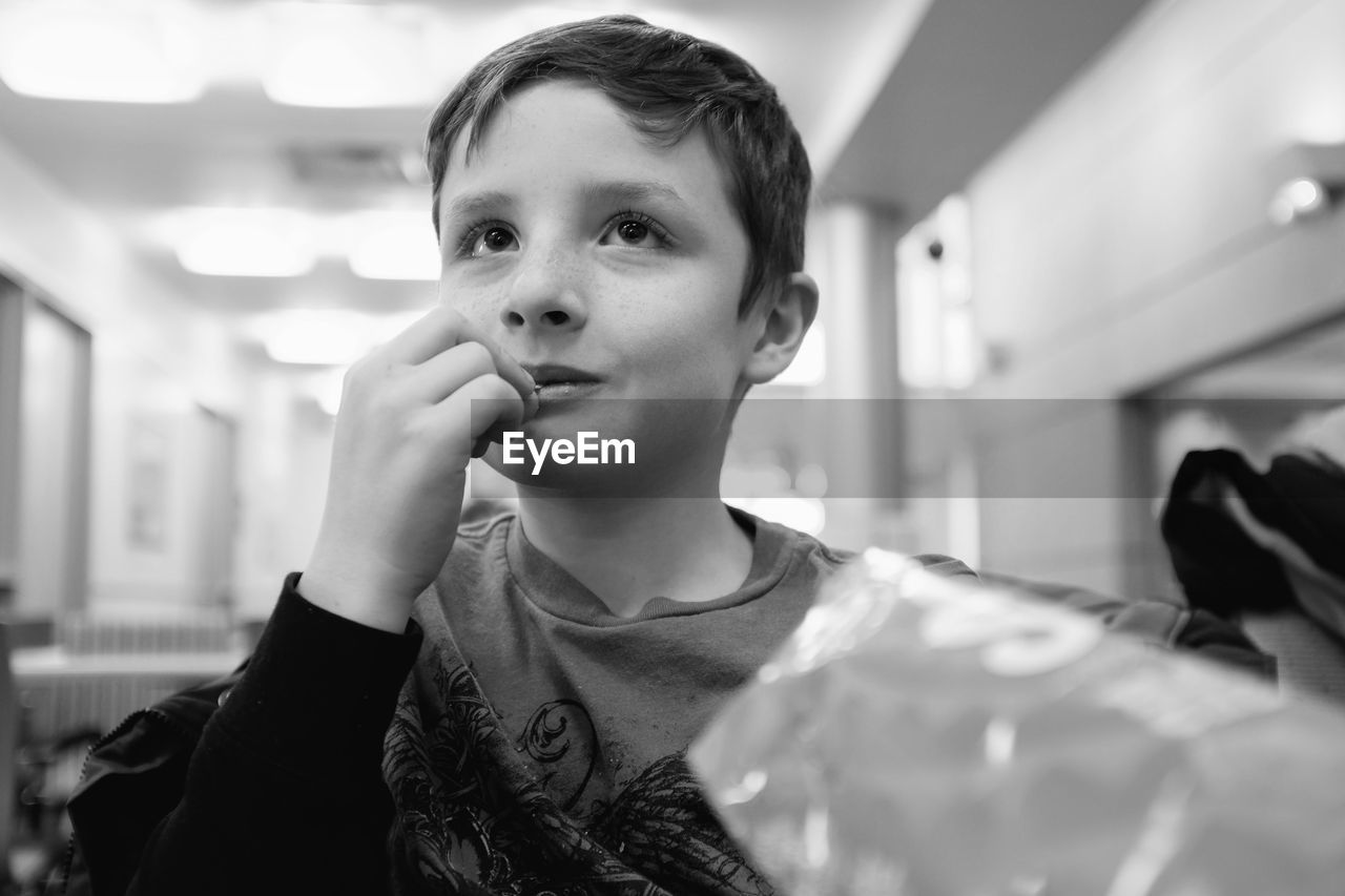 Close-up of boy having snacks at home