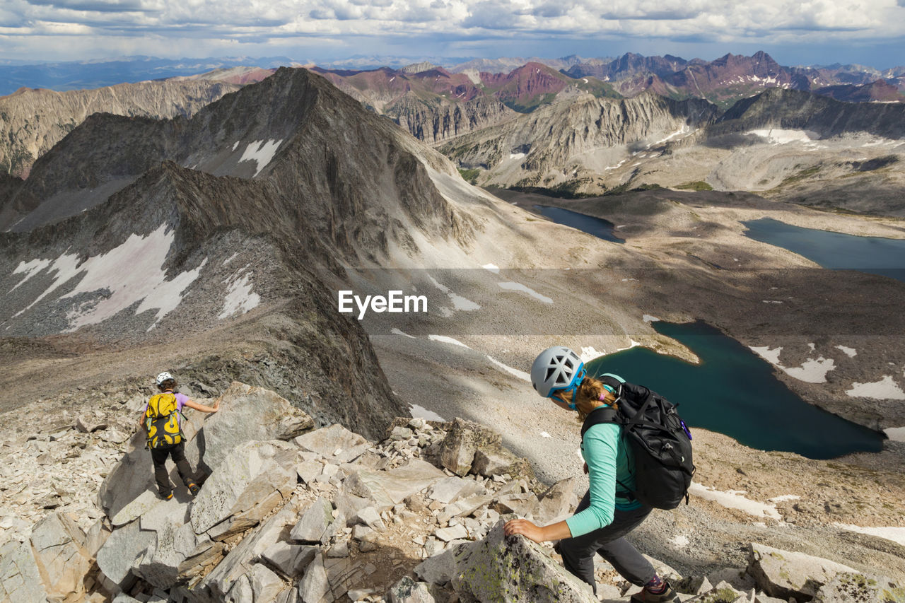 Women descend ridge on capitol peak, elk mountains, colorado