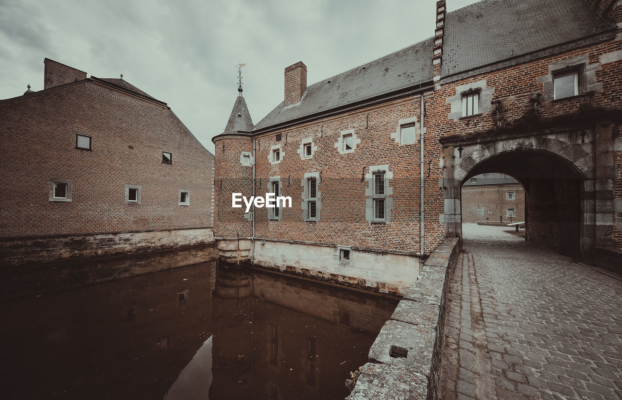 View of old building against cloudy sky