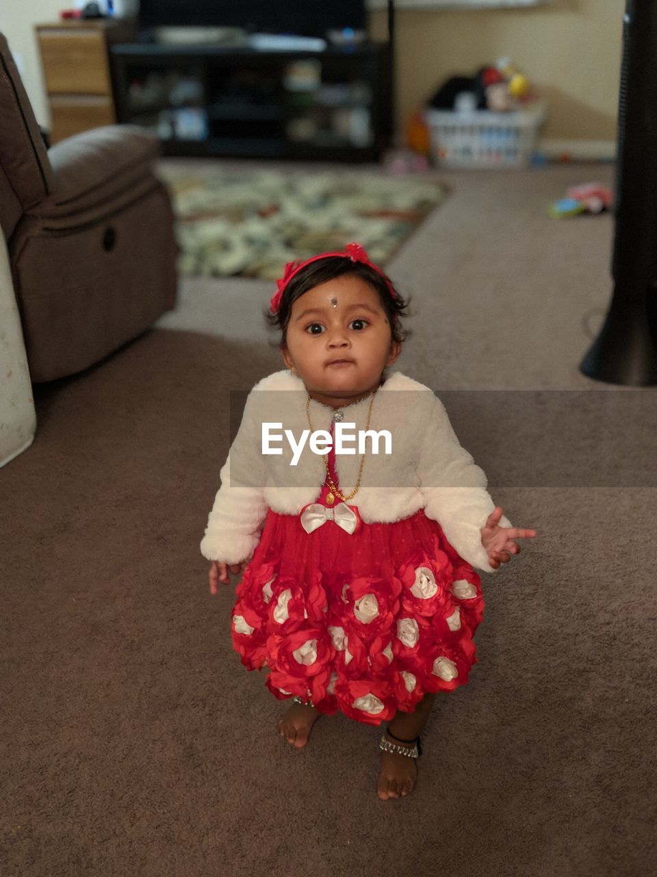 Portrait of baby girl standing at home