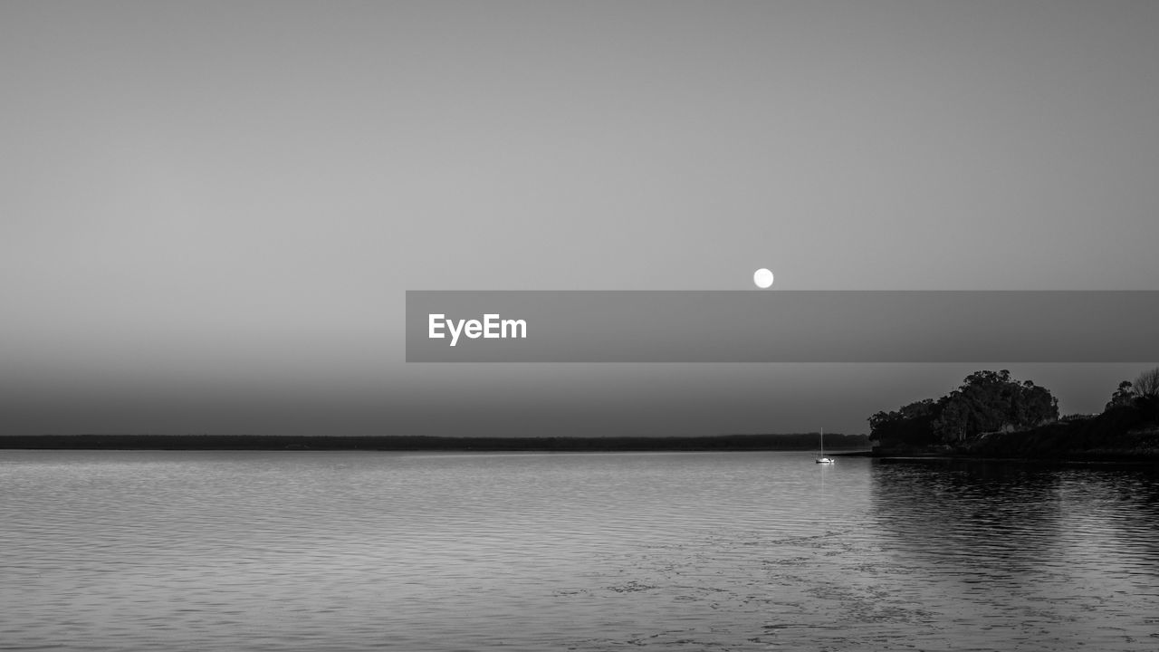 Scenic view of sea against clear sky at night