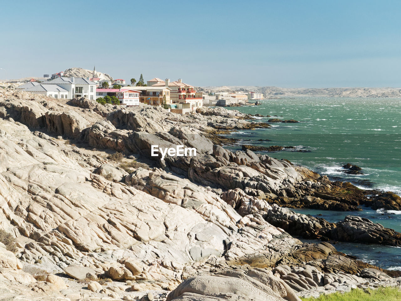 SCENIC VIEW OF SEA AGAINST BUILDINGS