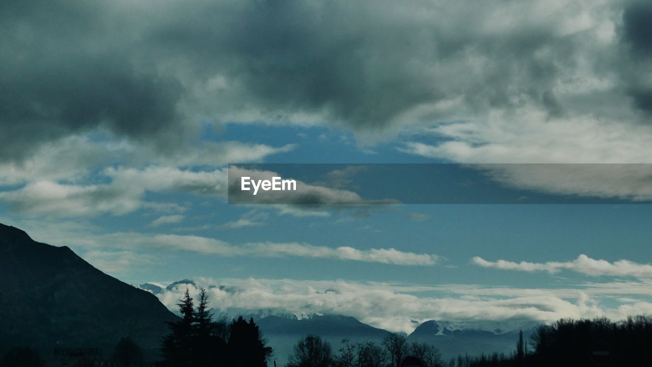 Low angle view of silhouette mountain against sky