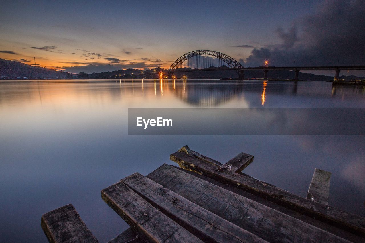 Scenic view of lake against sky at dusk