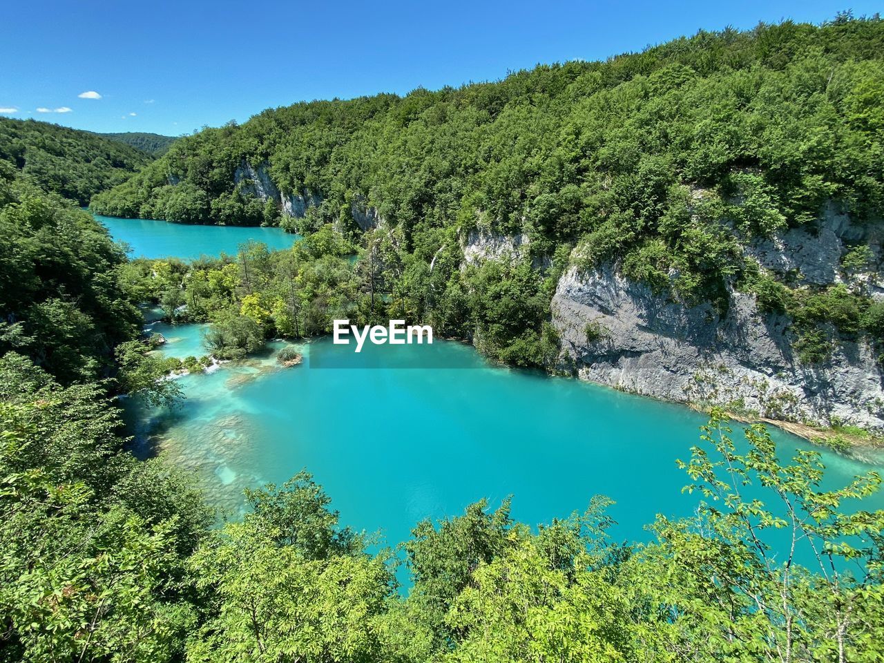 SCENIC VIEW OF LAKE AGAINST BLUE SKY