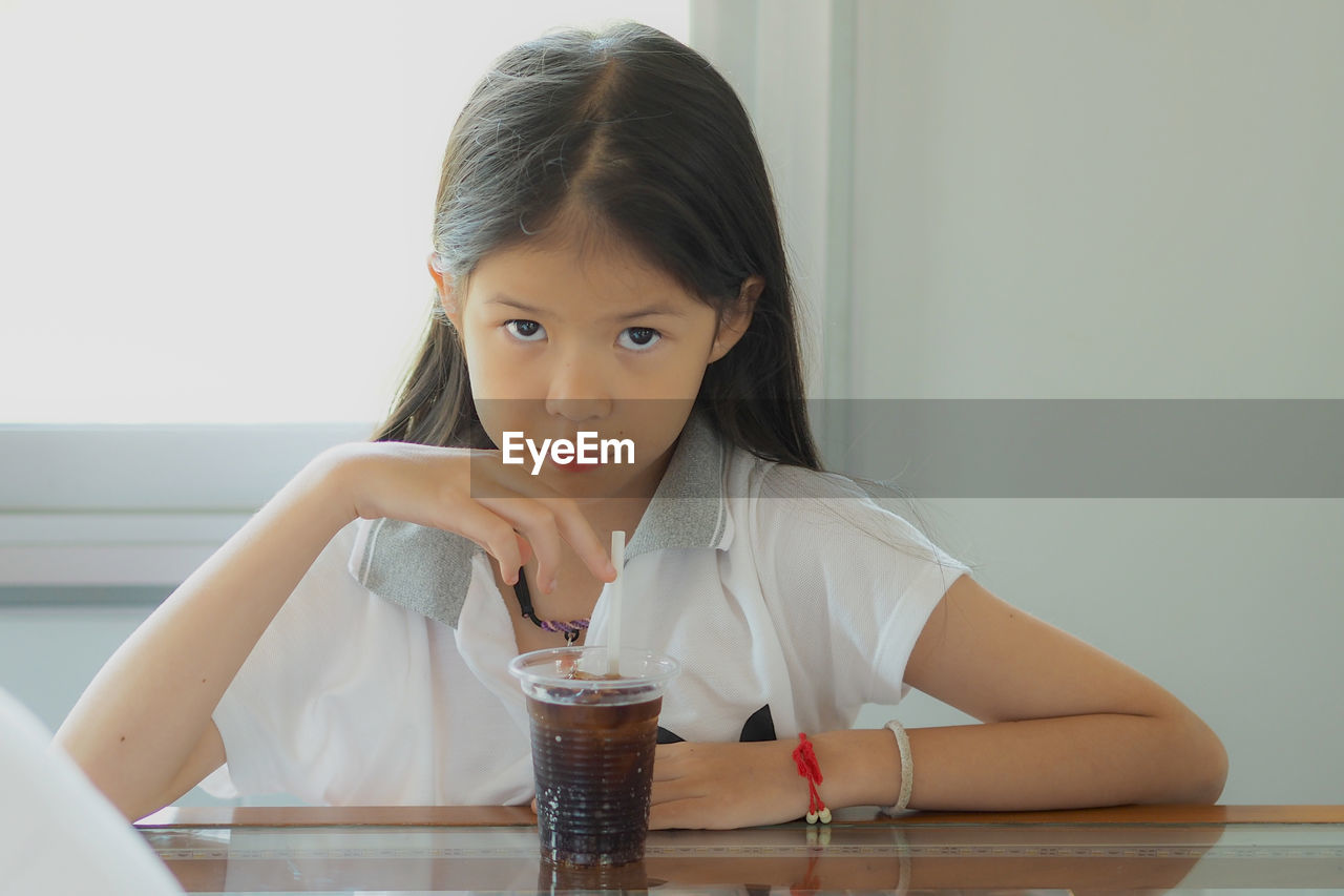 Portrait of girl sitting at table