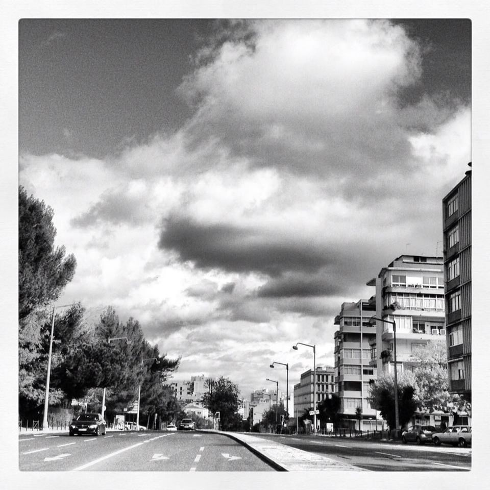 black and white, architecture, sky, city, cloud, building exterior, monochrome photography, built structure, tree, road, transportation, nature, street, car, residential area, monochrome, plant, motor vehicle, sign, no people, building, auto post production filter, mode of transportation, day, outdoors, transfer print, symbol, city life, land vehicle, road marking, residential district, city street