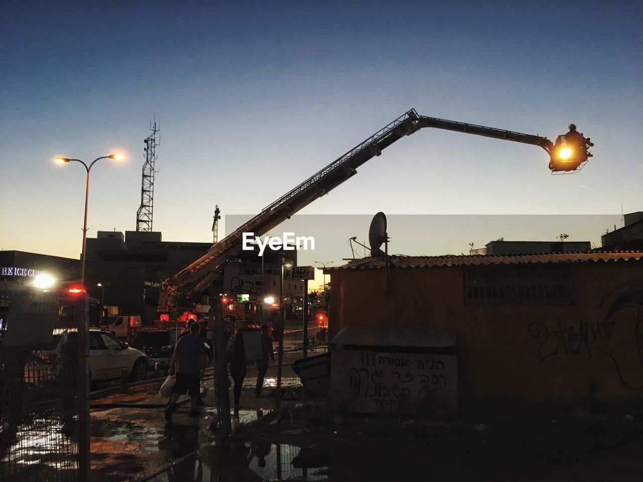 VIEW OF ILLUMINATED STREET LIGHT AGAINST SKY