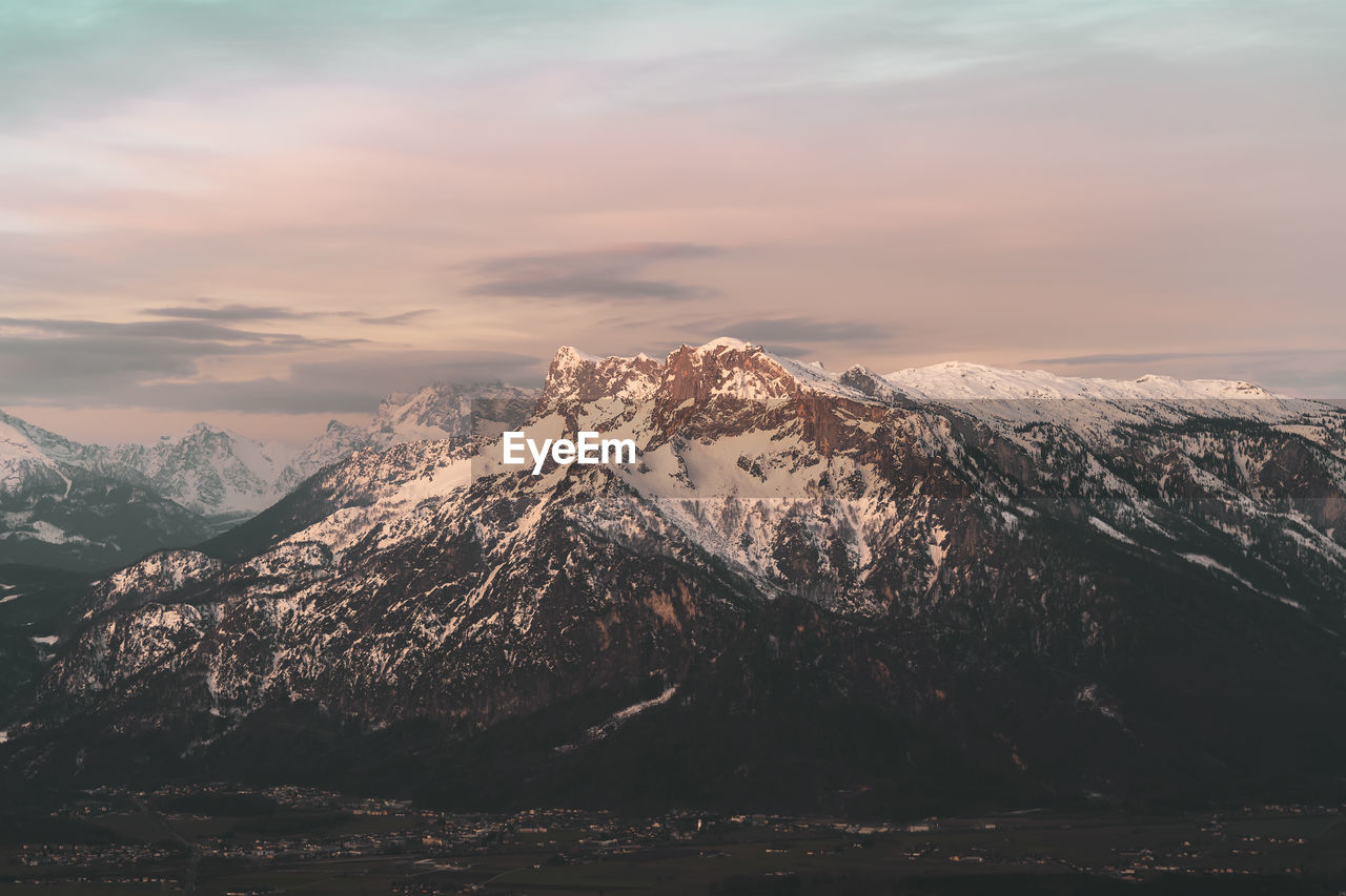 Scenic view of snowcapped mountains against sky during sunset