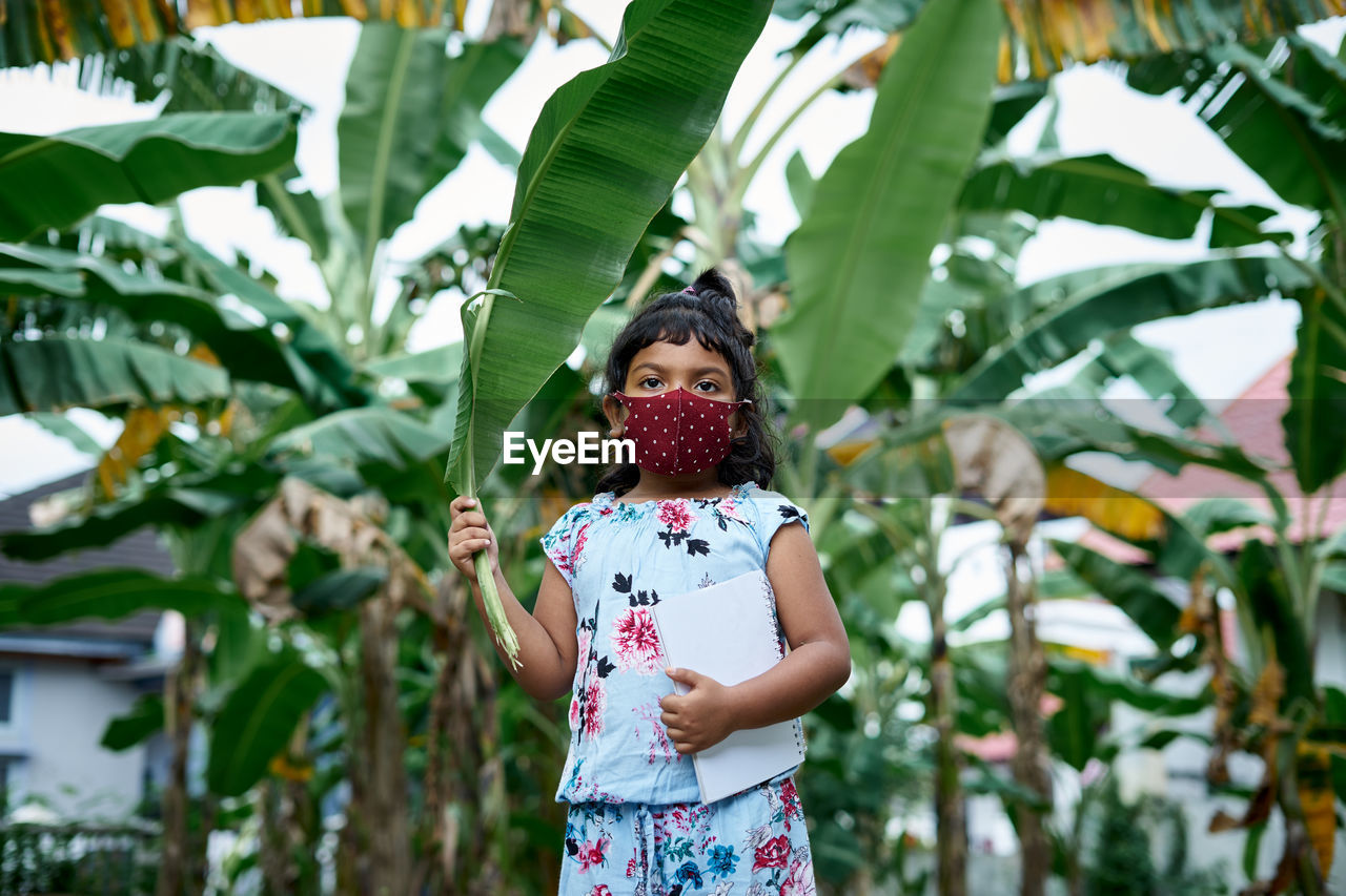 Low section of woman standing on plant