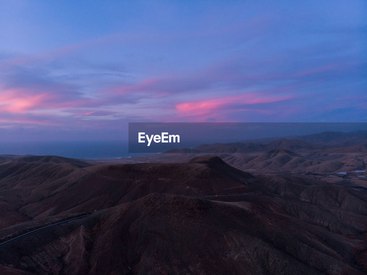 Scenic view of mountains against sky during sunset