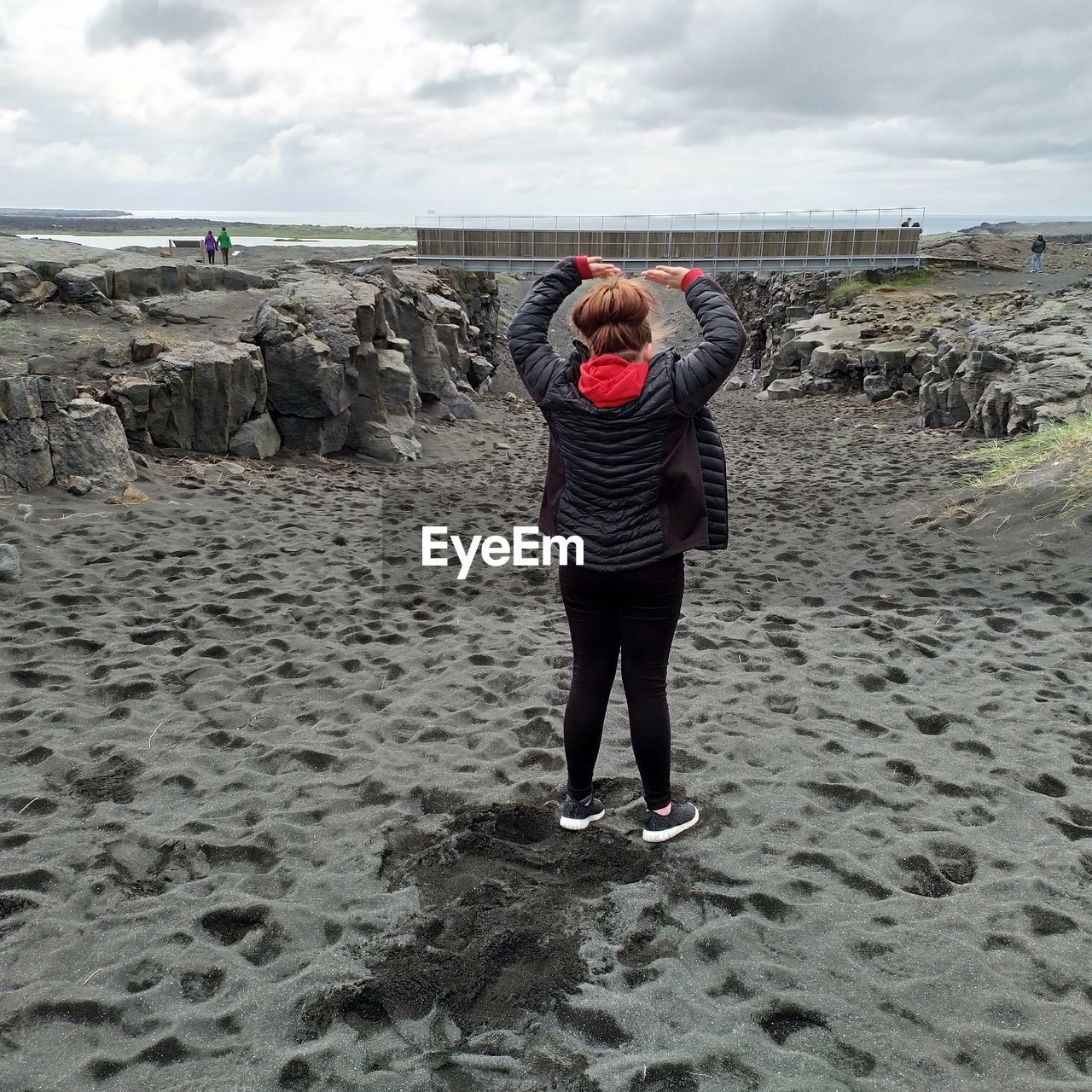 Full length rear view of girl standing at beach