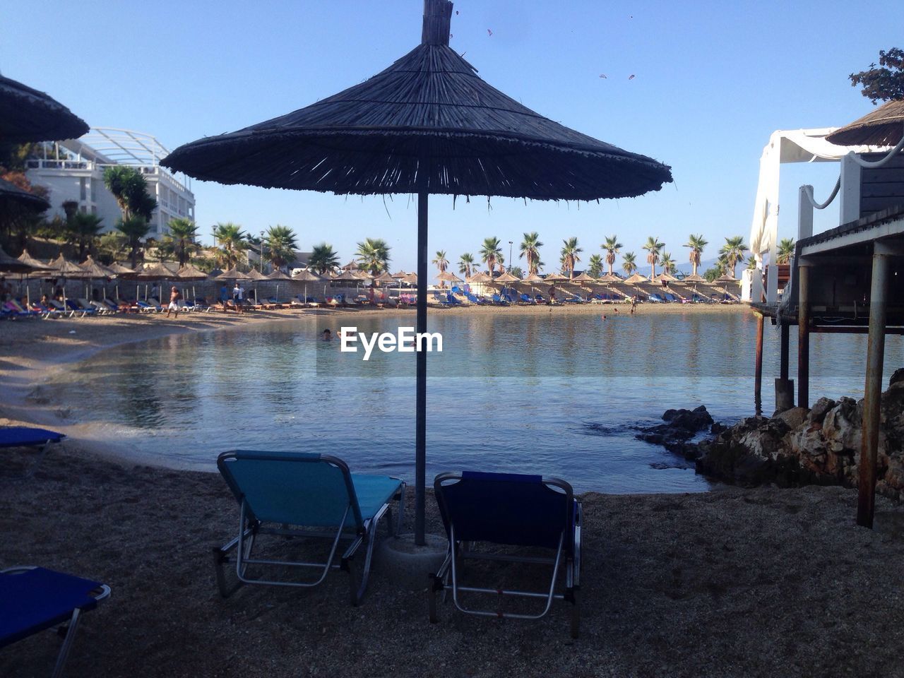 Deck chairs and tables at seaside