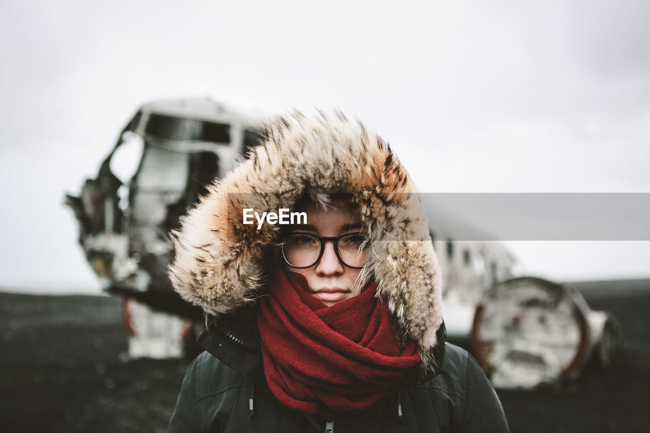 Adventurous portrait of young female infront of famous icelandic wreck