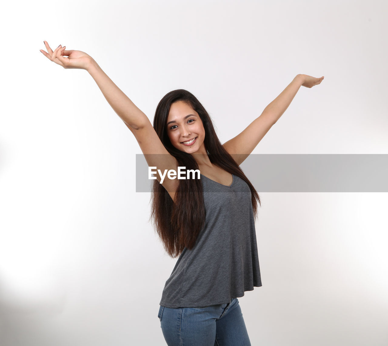 PORTRAIT OF YOUNG WOMAN AGAINST WHITE BACKGROUND