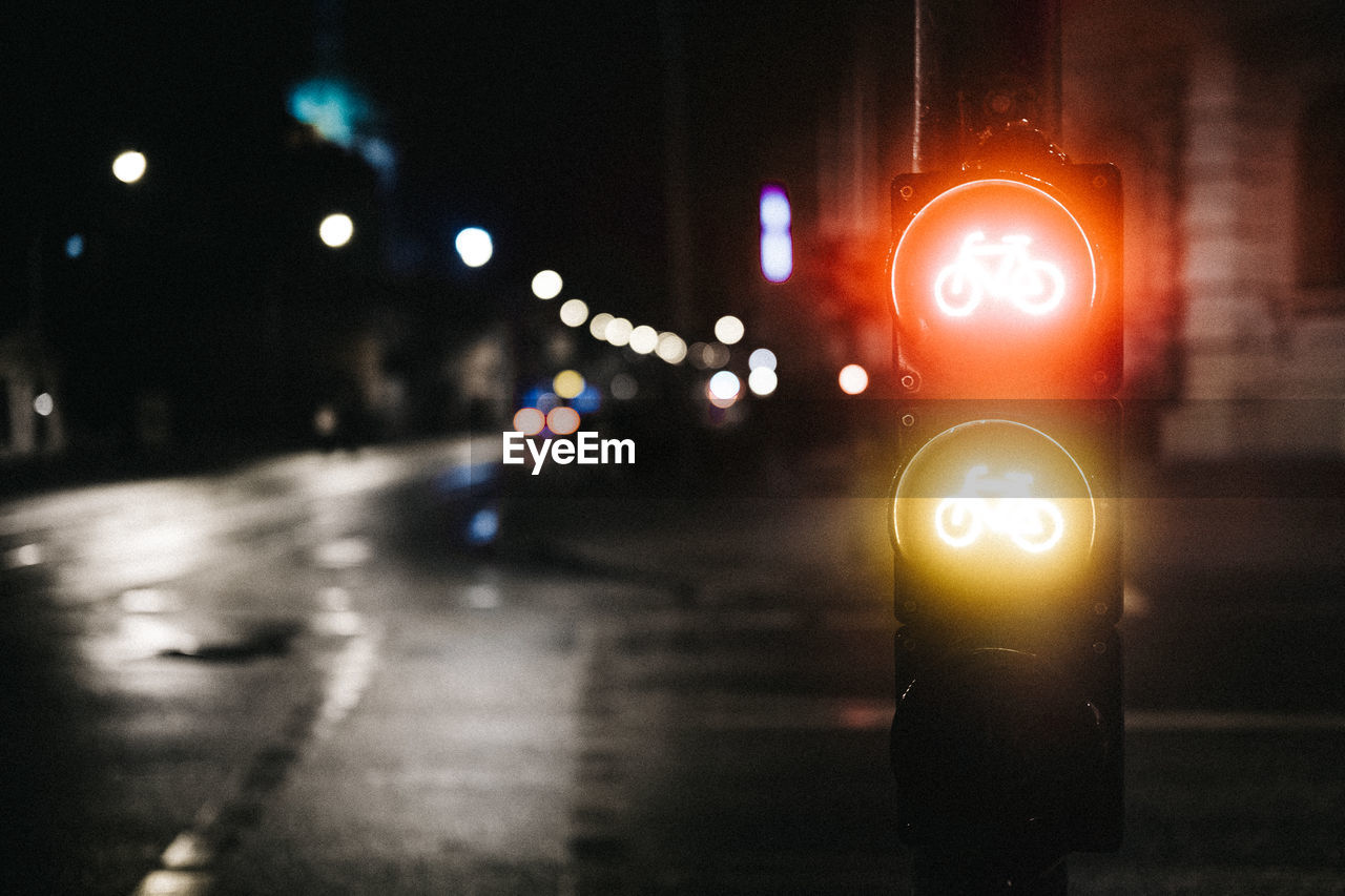 Close-up of illuminated road signal at night