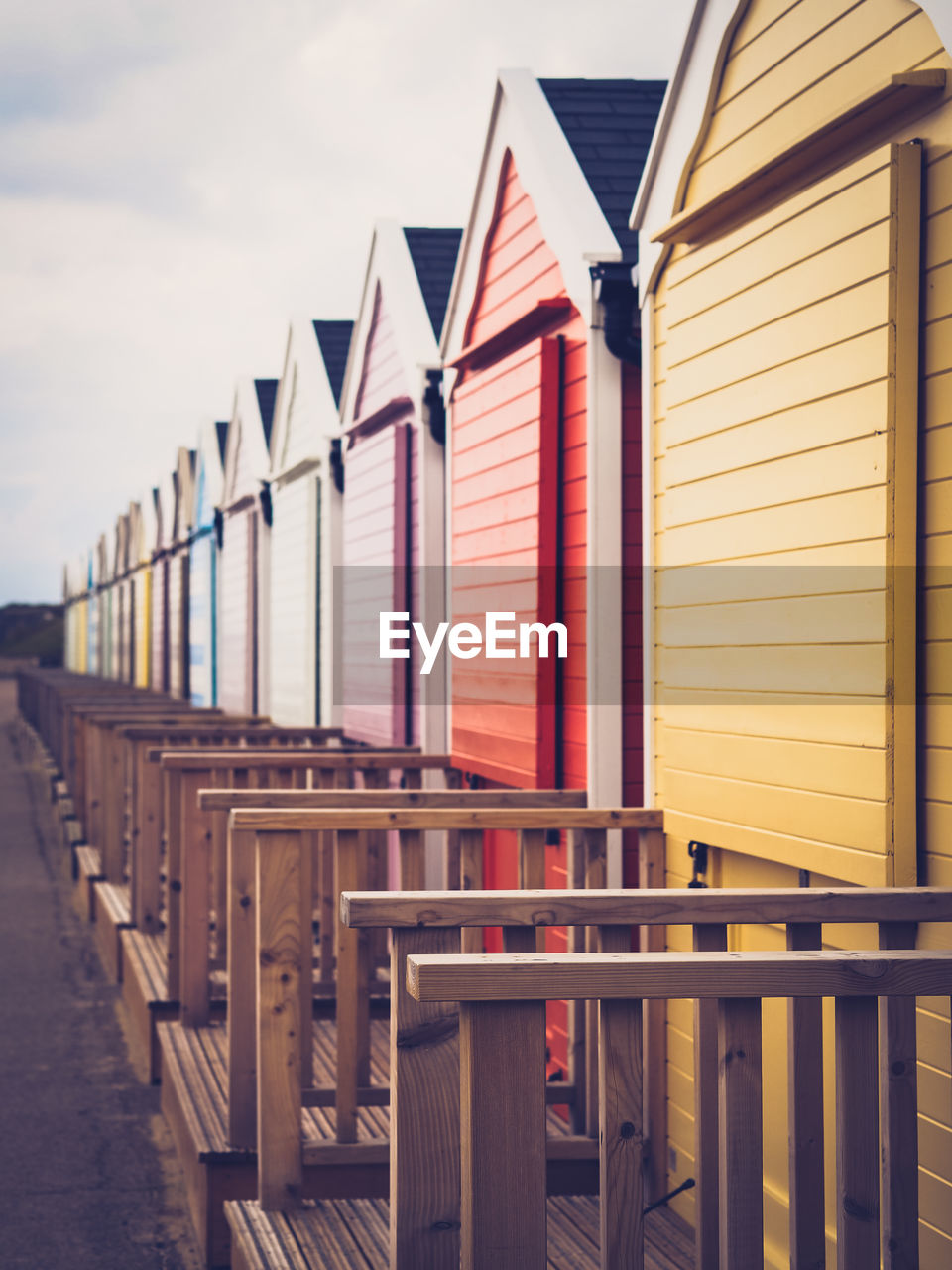 Row of bech huts on norfolk coast close up