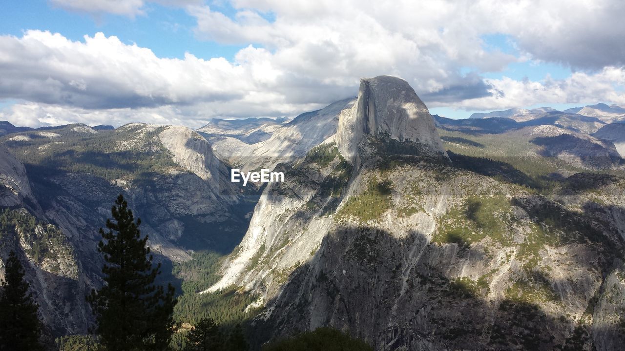 Scenic view of mountains against cloudy sky