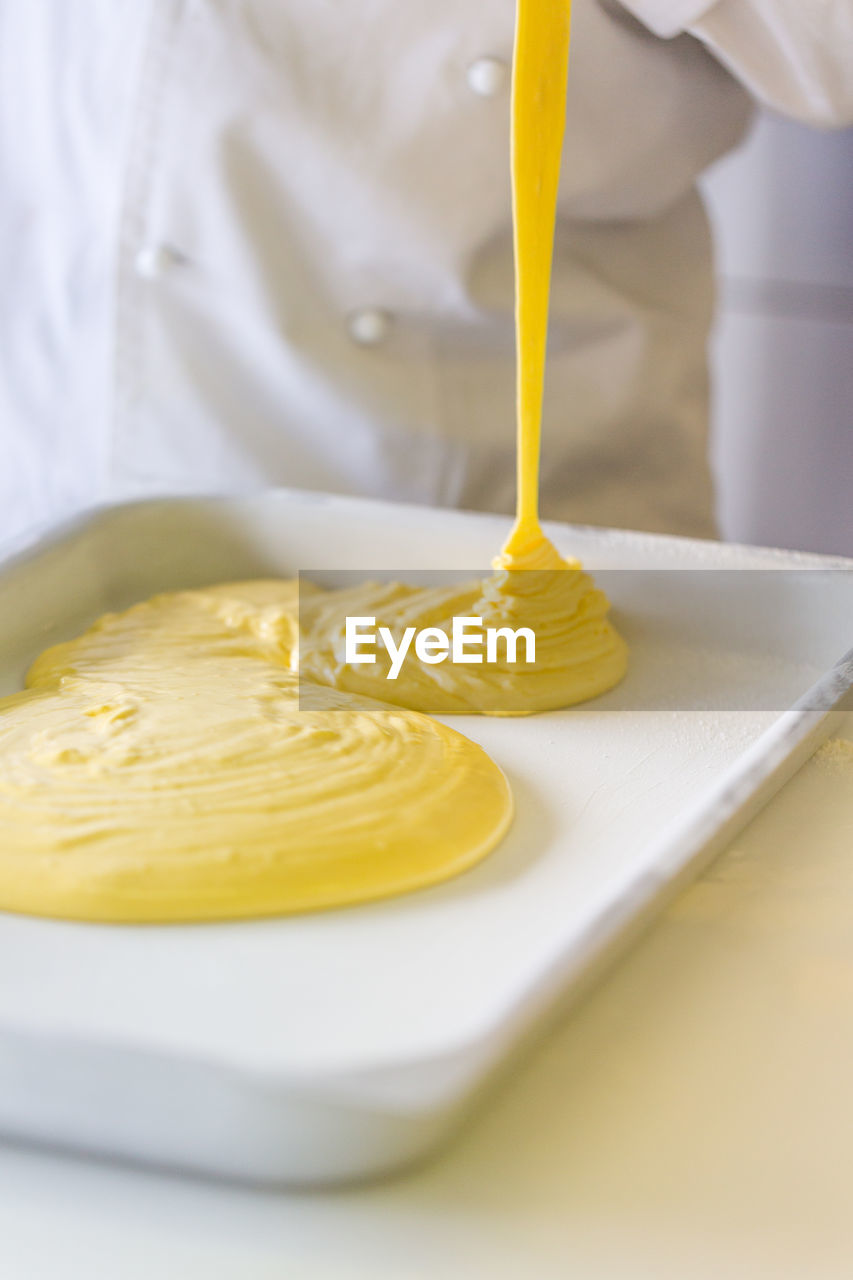 Close-up of yellow cream on table