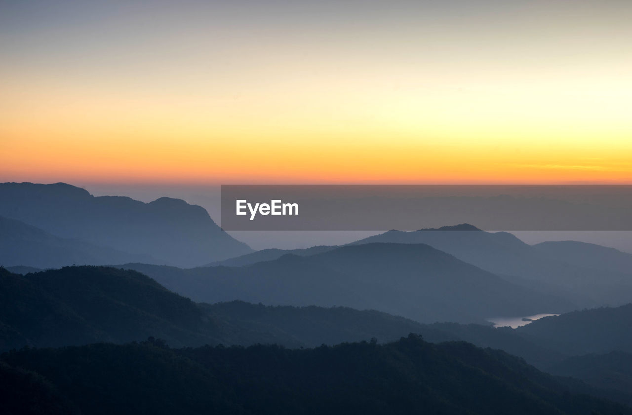 Scenic view of silhouette mountains ,  nature beautiful sunrise on top of thailand mountain