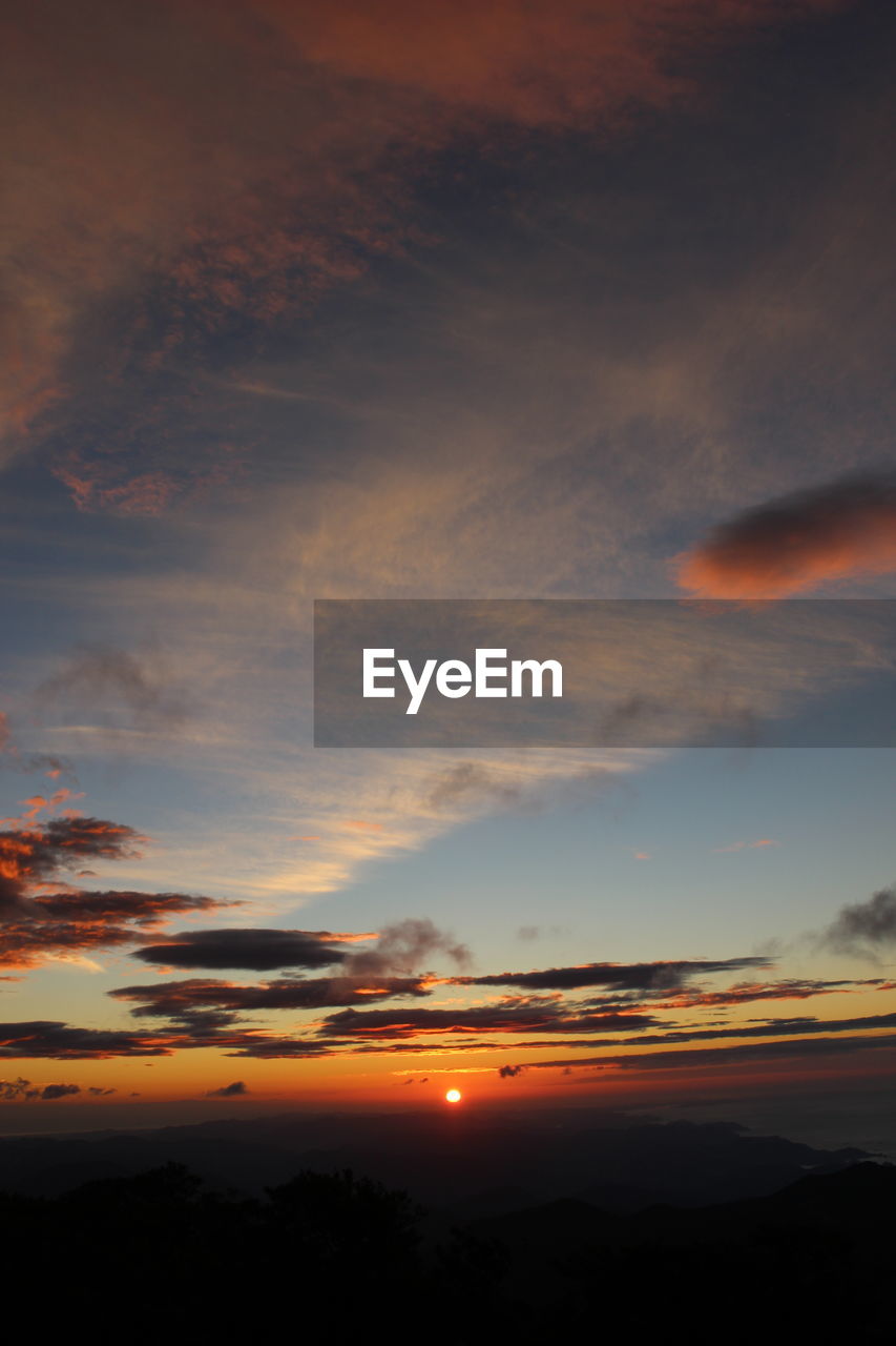 LOW ANGLE VIEW OF DRAMATIC SKY OVER SILHOUETTE LANDSCAPE