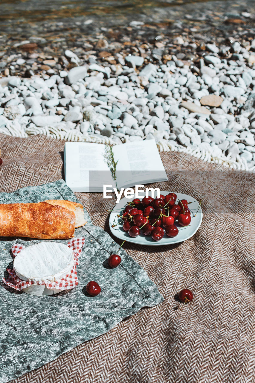 food and drink, food, healthy eating, fruit, freshness, wellbeing, berry, no people, high angle view, day, nature, art, table, outdoors, flooring, red, still life, beach, meal, land