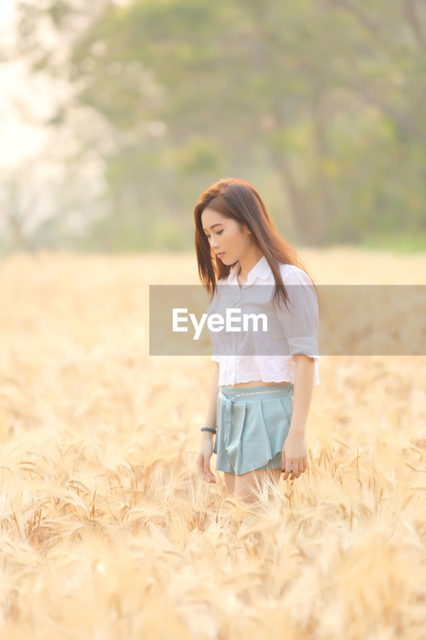 Young woman standing on field