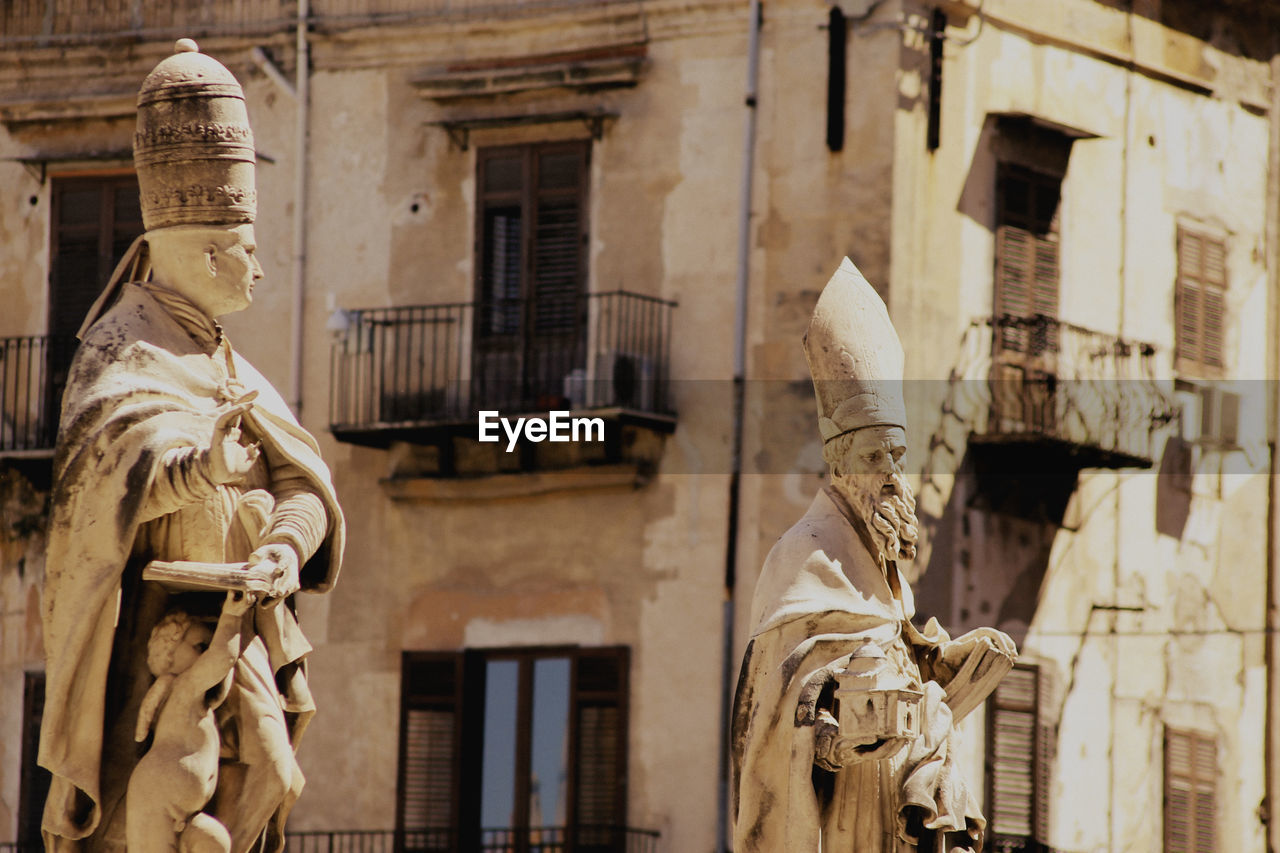 Statues against building in city