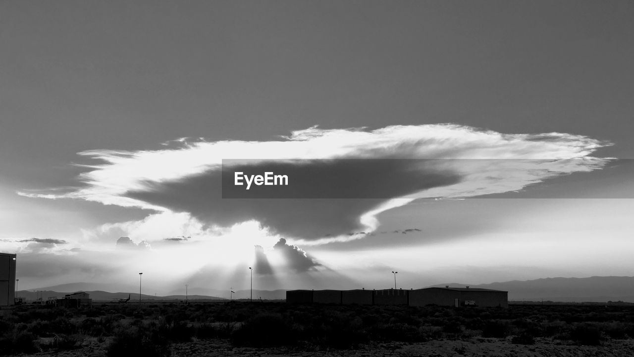 SMOKE STACK AGAINST CLOUDY SKY