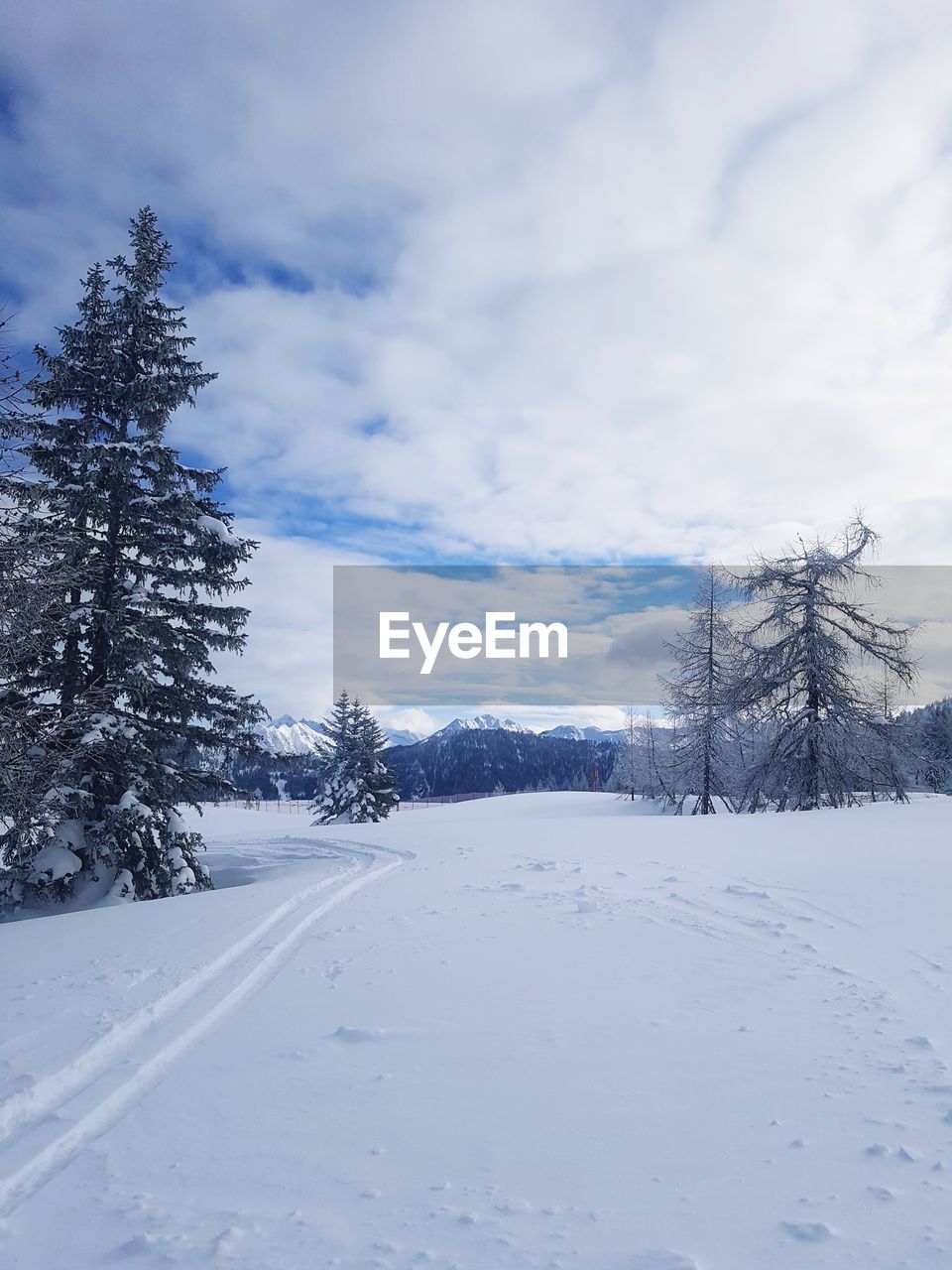 SNOW COVERED LAND AGAINST SKY