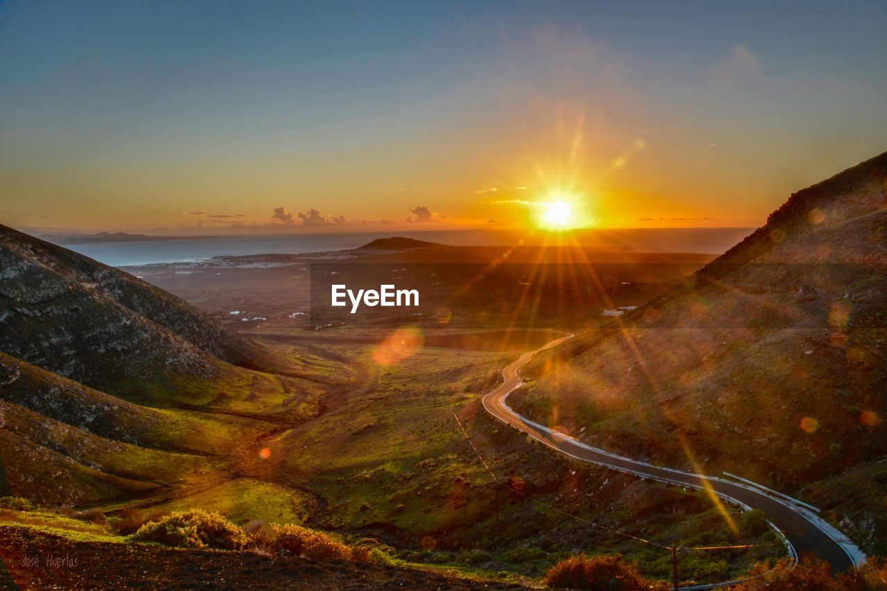 Scenic view of landscape against sky during sunset in lanzarote