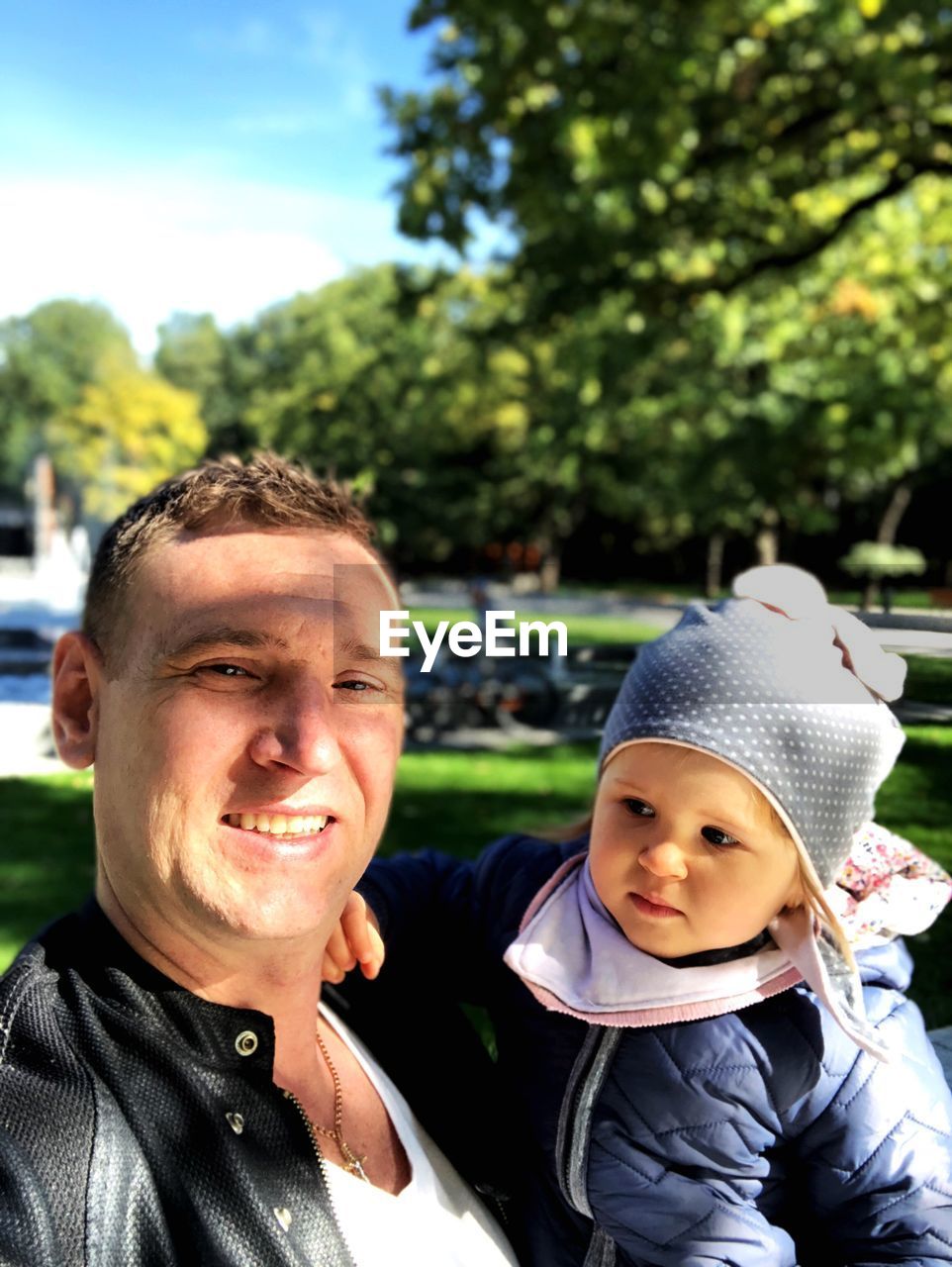 Portrait of father and daughter at park