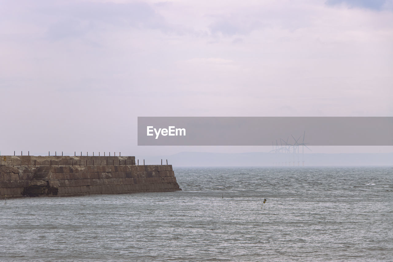 water, sea, sky, shore, nature, ocean, architecture, coast, cloud, beauty in nature, scenics - nature, built structure, horizon, tower, no people, tranquility, tranquil scene, land, day, horizon over water, outdoors, breakwater, body of water, building exterior, waterfront, nautical vessel, bay, wave, travel, travel destinations, beach, environment, non-urban scene