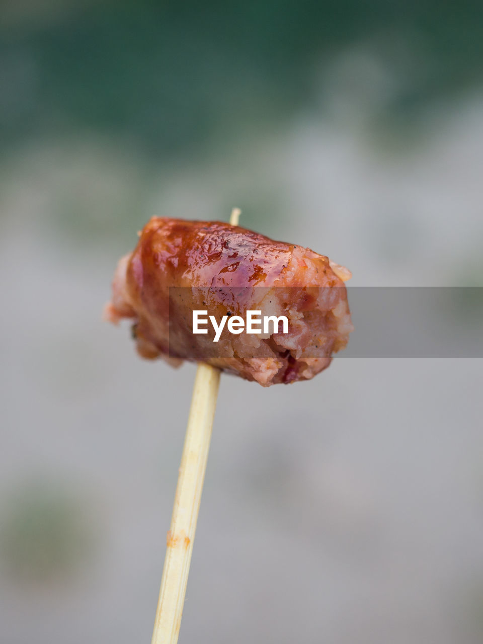 Close-up of spicy thai sausage on stick