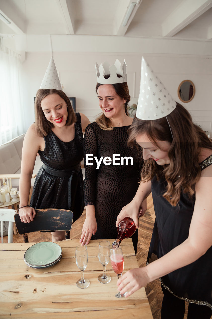 Portrait of smiling women celebrating at home