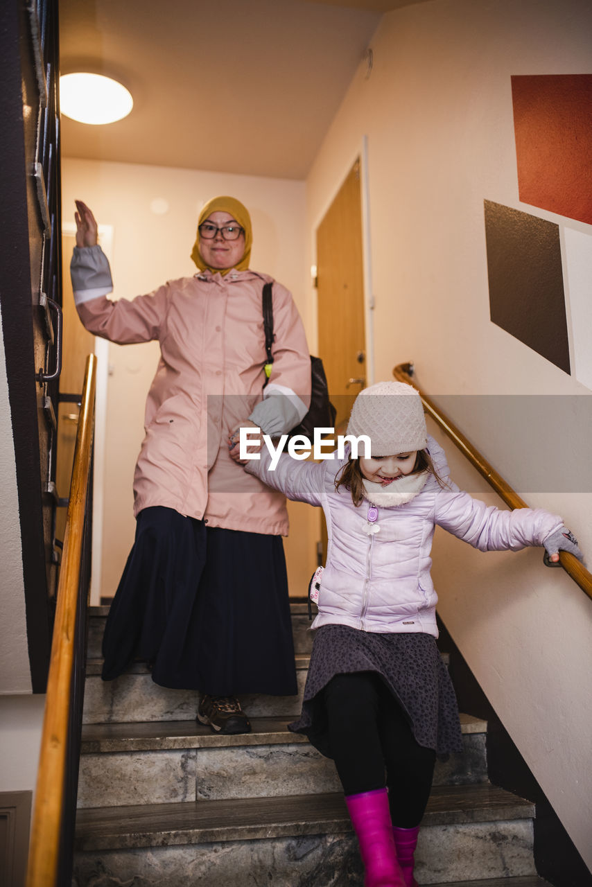 Mother with daughter on staircase