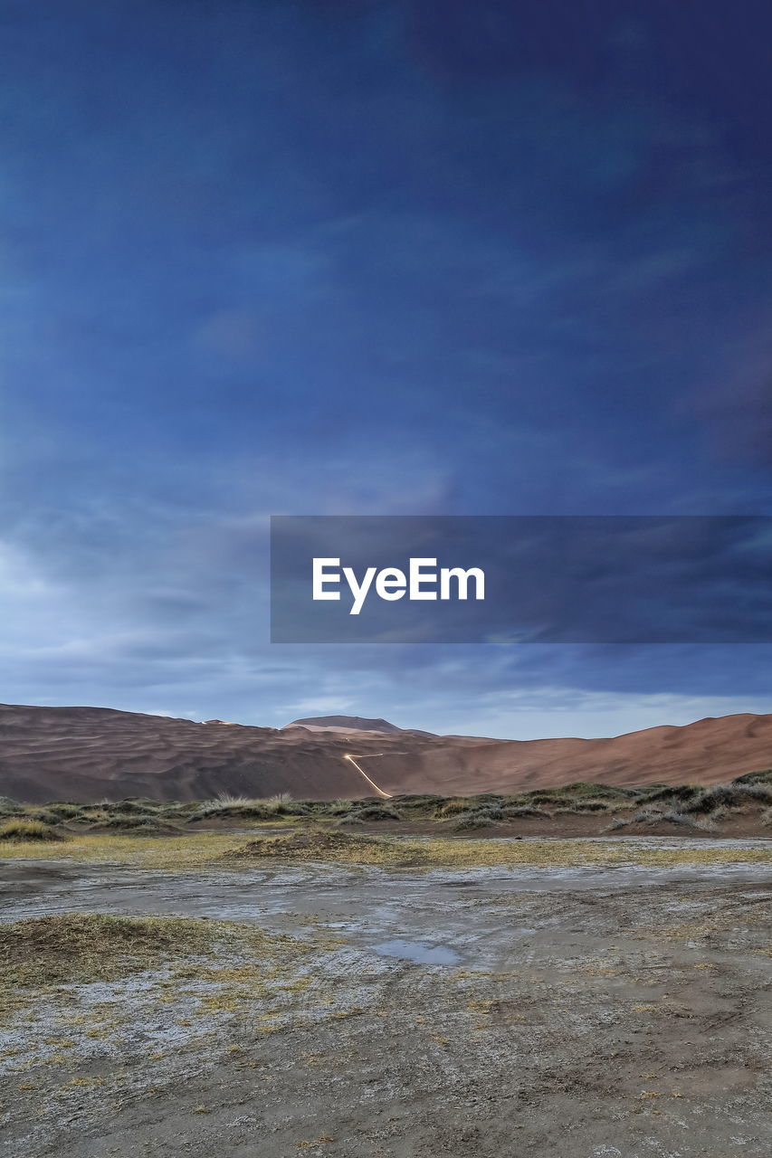 1121 sumu jaran lakebed among badain jaran desert megadunes-sunset leaden sky -inner mongolia-china.