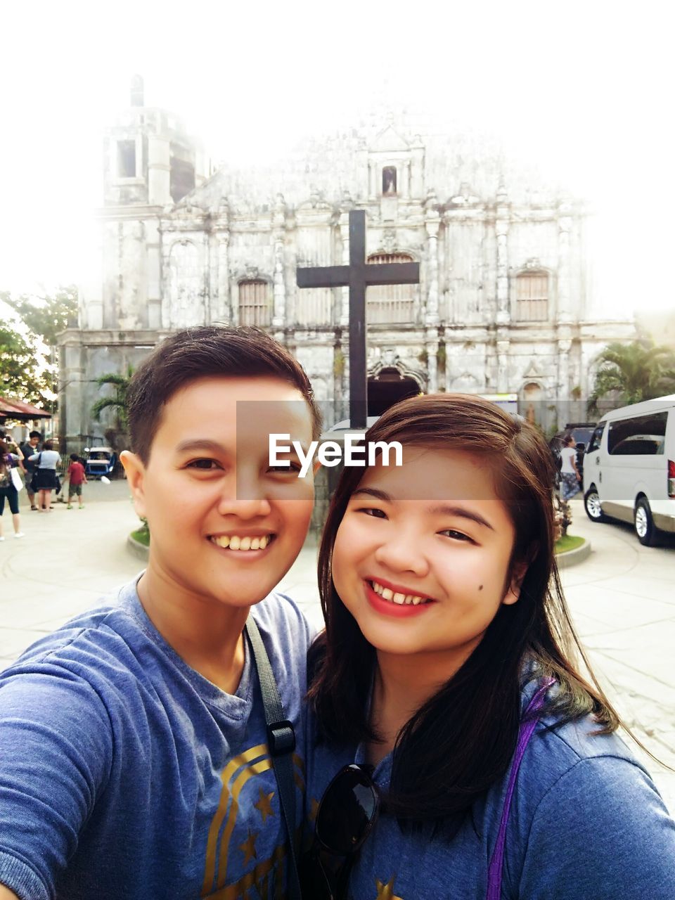 Portrait of a smiling couple by church