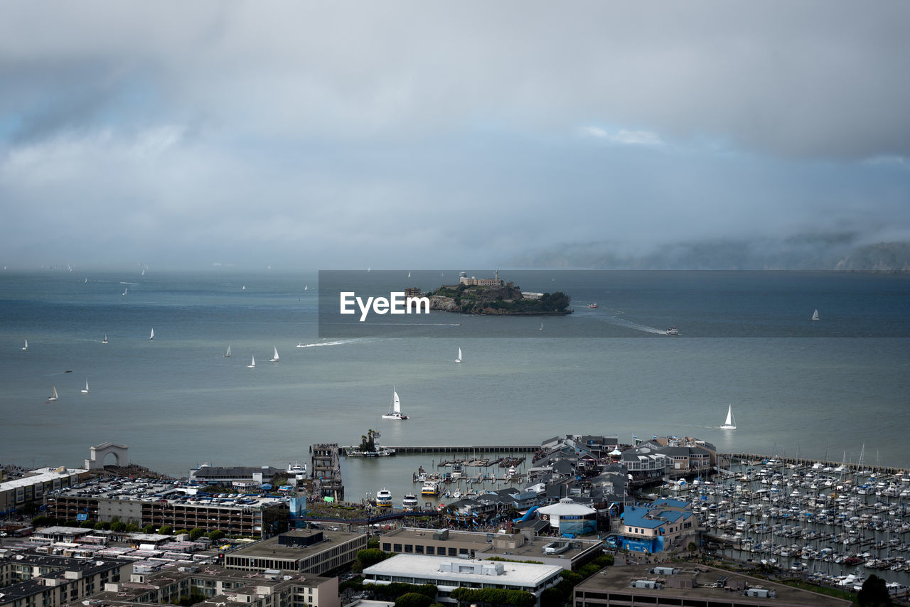 HIGH ANGLE VIEW OF SEA AGAINST BUILDINGS IN CITY