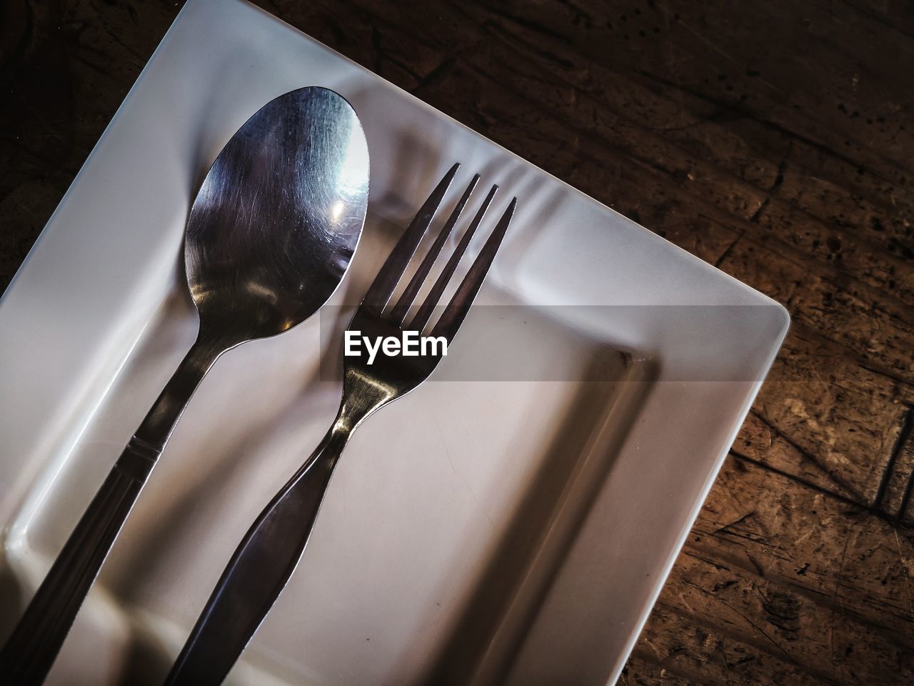 High angle view of fork in plate on table