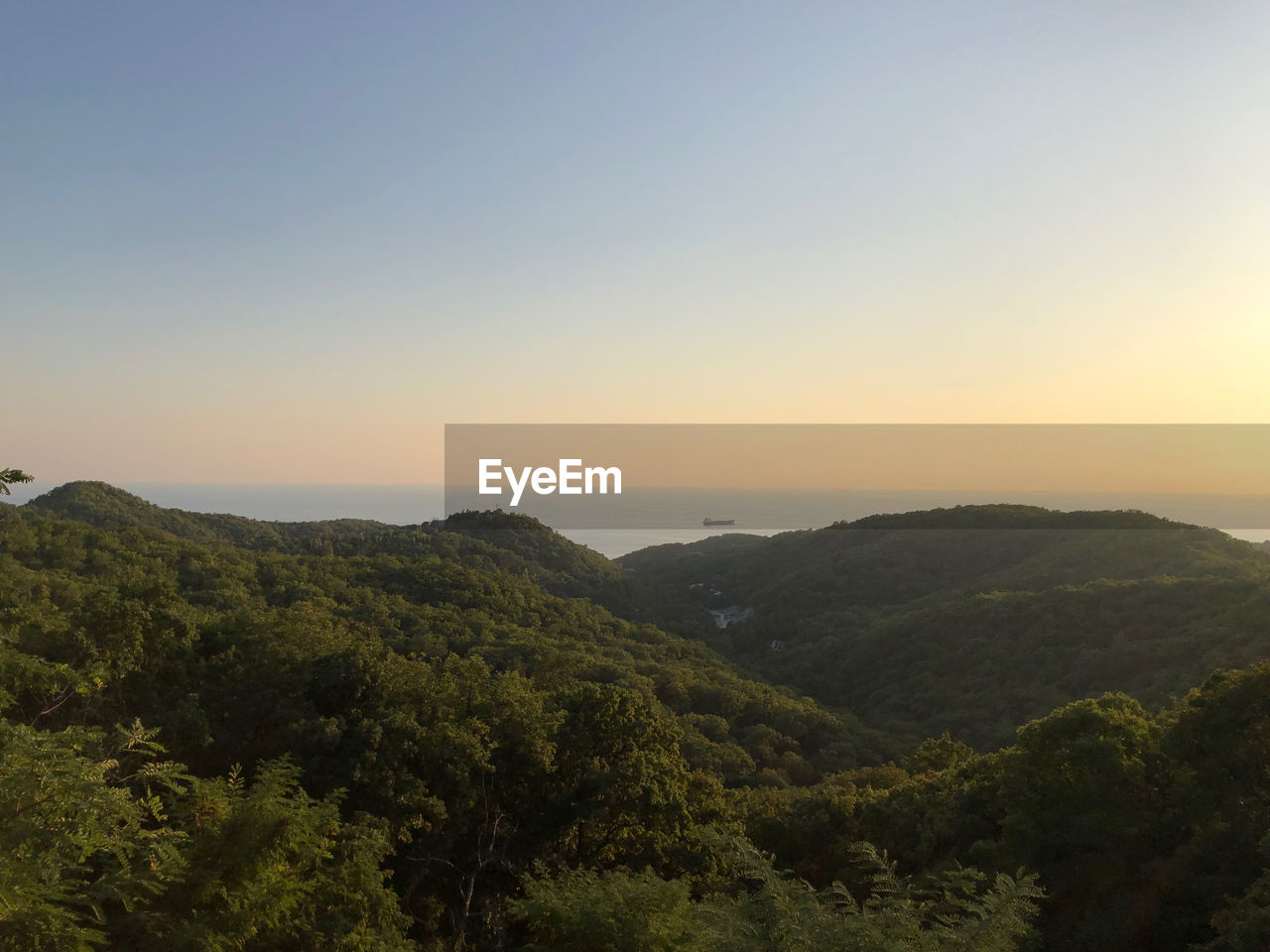 Scenic view of mountains against clear sky during sunset