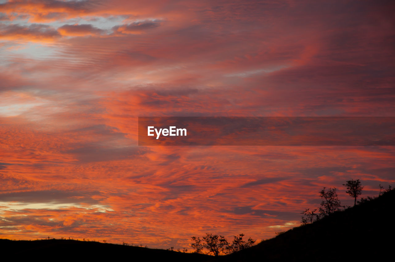 Low angle view of dramatic sky during sunset