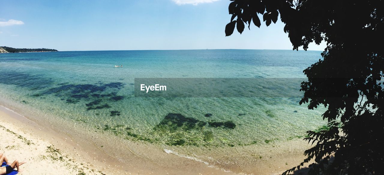 SCENIC VIEW OF BEACH AGAINST BLUE SKY