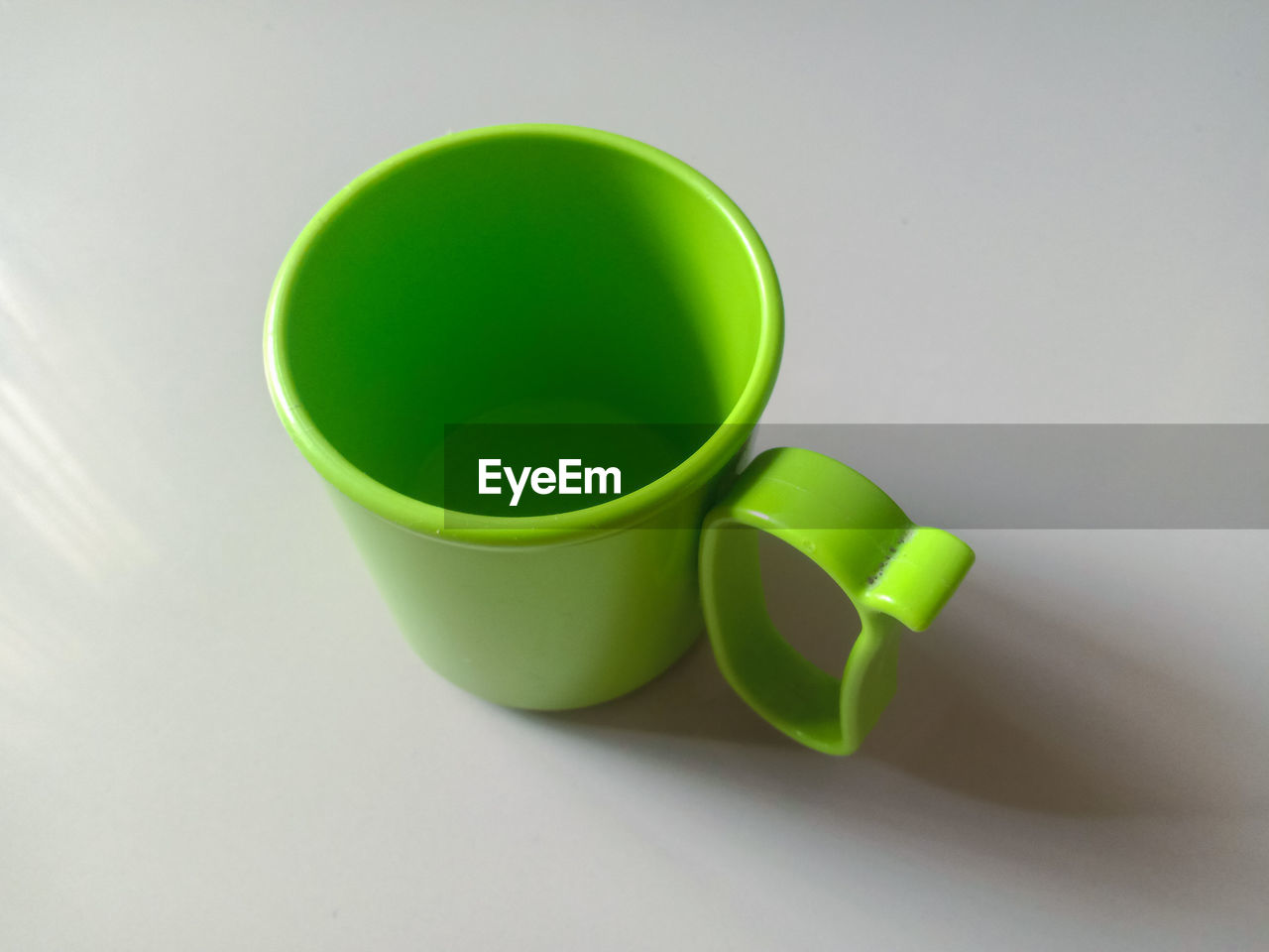 green, cup, coffee cup, indoors, yellow, no people, studio shot, circle, drink, food and drink, high angle view, mug, still life, refreshment, close-up, white background, ceramic